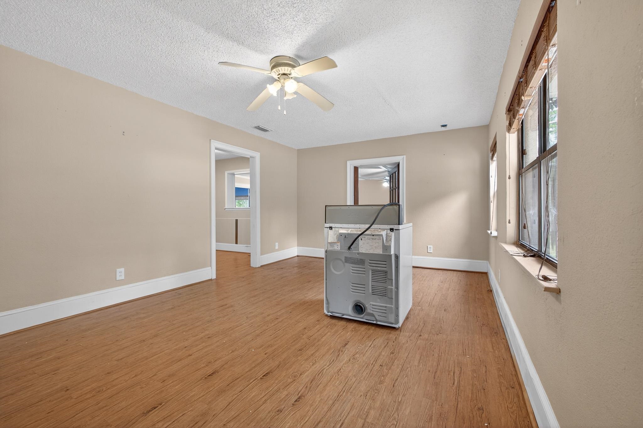 2907 North 5th Street St. Augustine, FL 32084 - Photo 49 of 71 Unfurnished living room with plenty of natural light, ceiling fan, light wood-style floors, and a textured ceiling