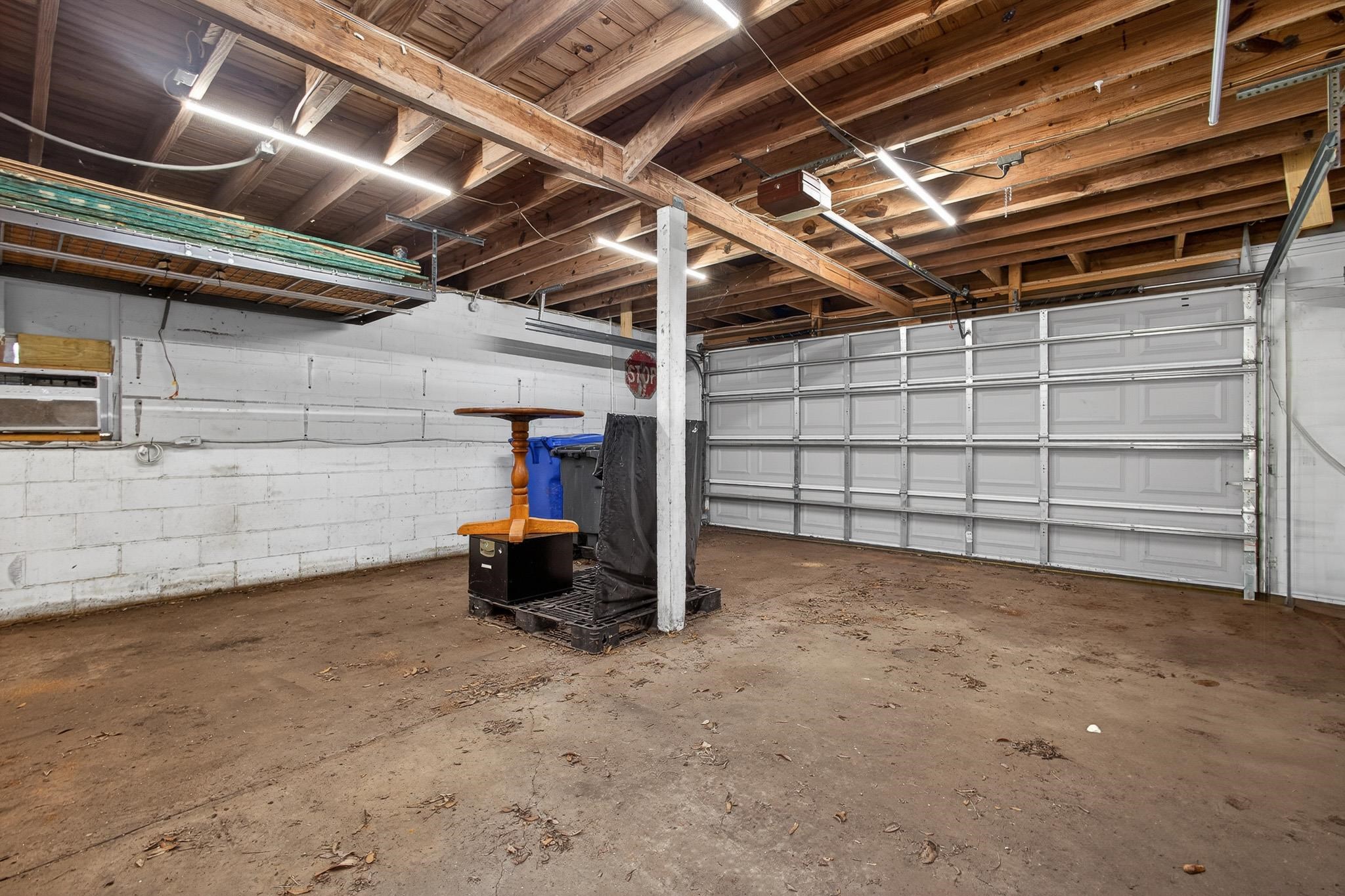 2907 North 5th Street St. Augustine, FL 32084 - Photo 60 of 71 Garage with concrete block wall and a garage door opener
