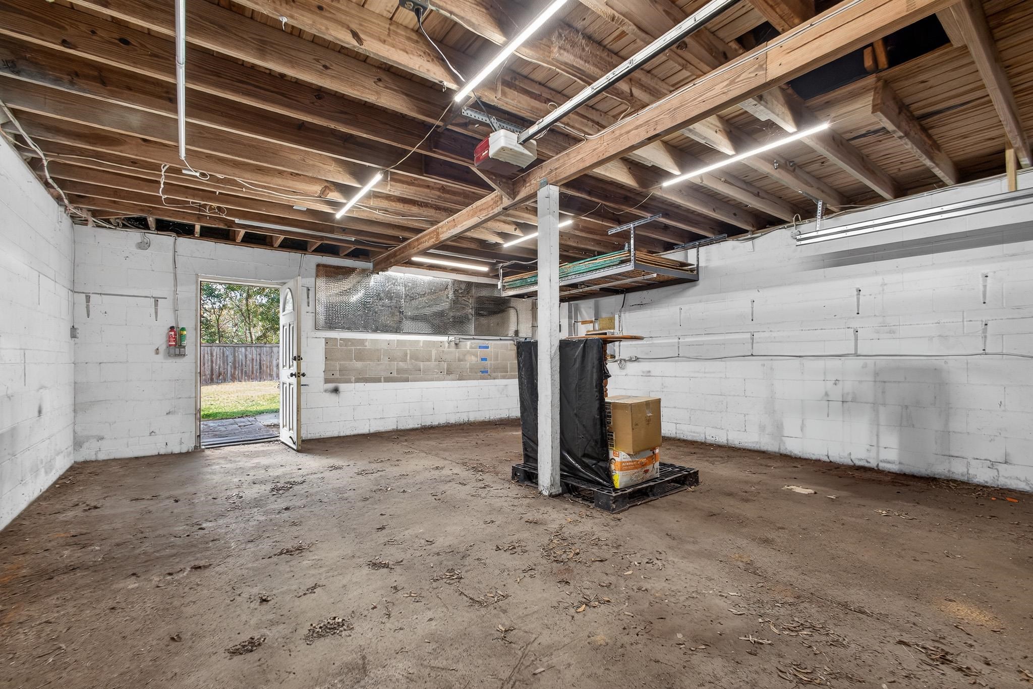 2907 North 5th Street St. Augustine, FL 32084 - Photo 61 of 71 Garage with concrete block wall and a garage door opener