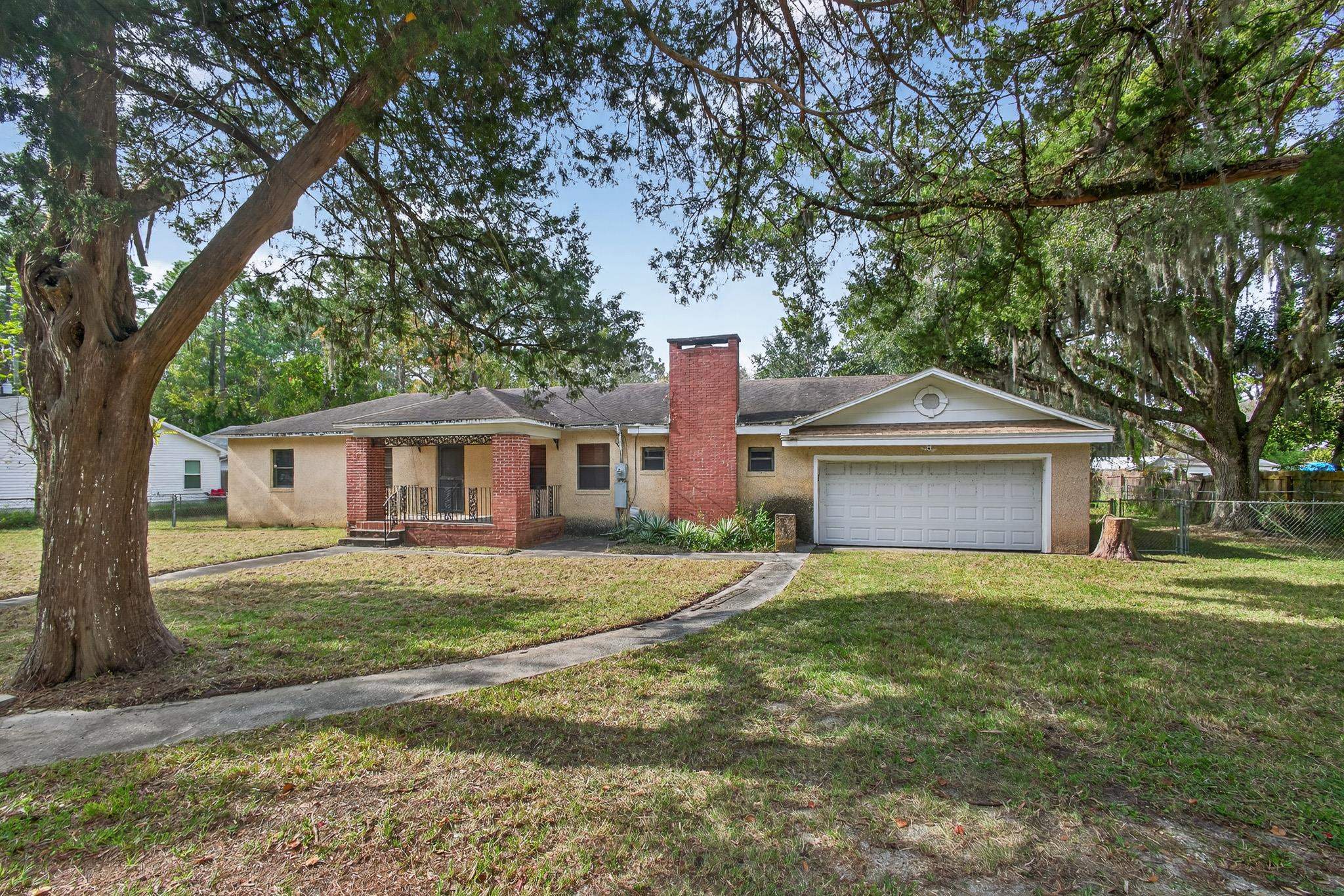2907 North 5th Street St. Augustine, FL 32084 - Photo 66 of 71 Ranch-style house featuring a chimney, a garage, and brick siding
