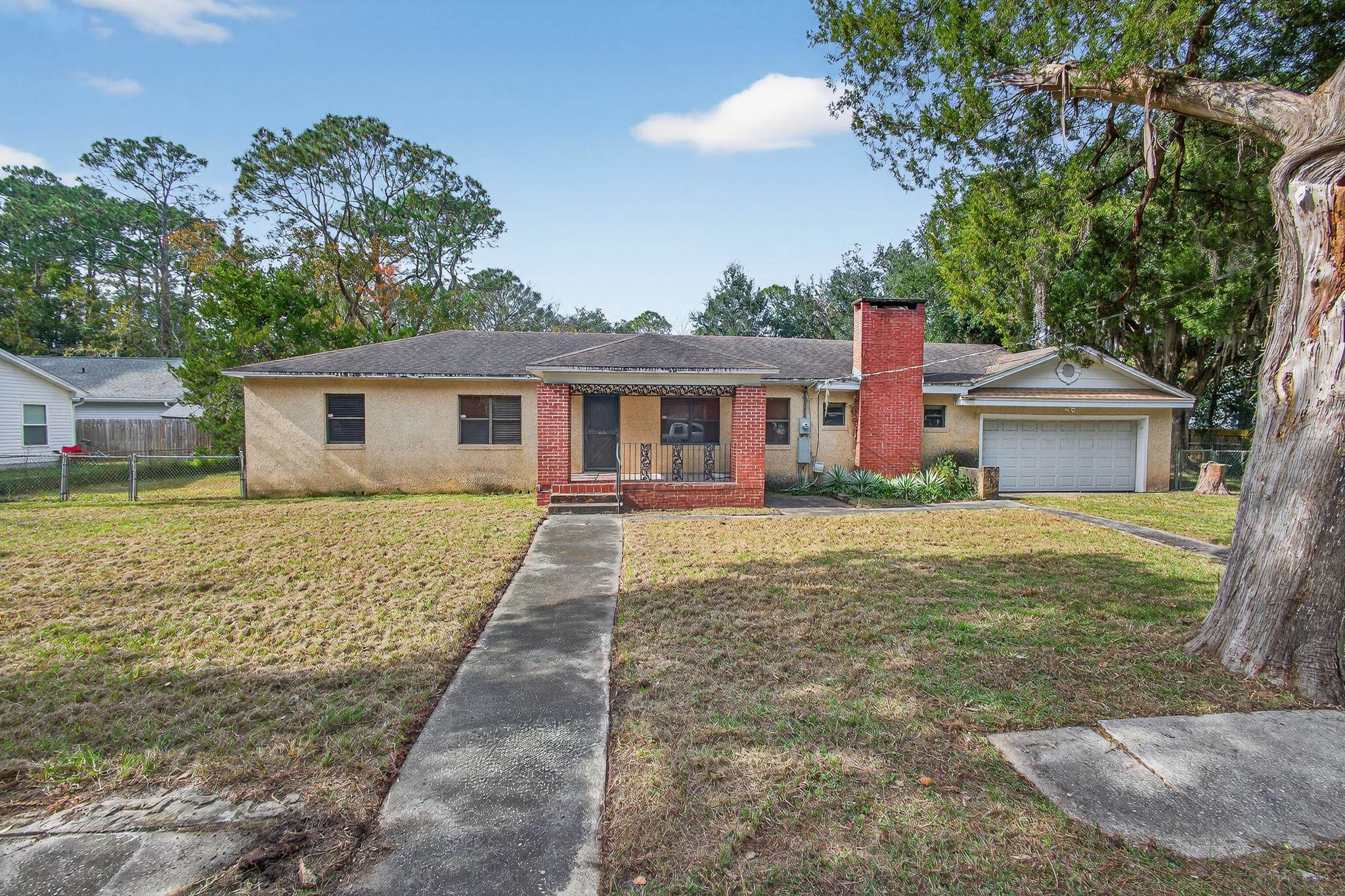 2907 North 5th Street St. Augustine, FL 32084 - Photo 67 of 71 Single story home with a chimney, brick siding, covered porch, and a garage