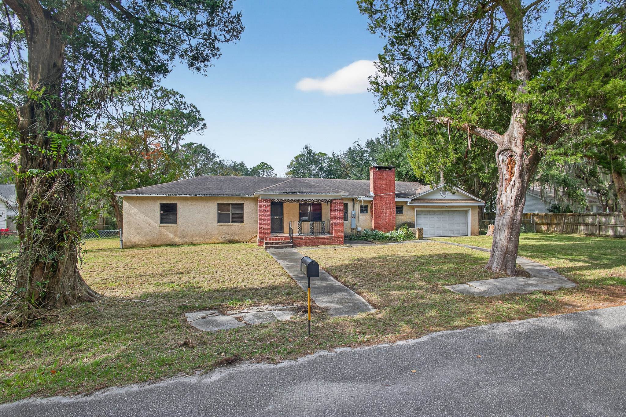 2907 North 5th Street St. Augustine, FL 32084 - Photo 68 of 71 Ranch-style home featuring a chimney, brick siding, and a garage