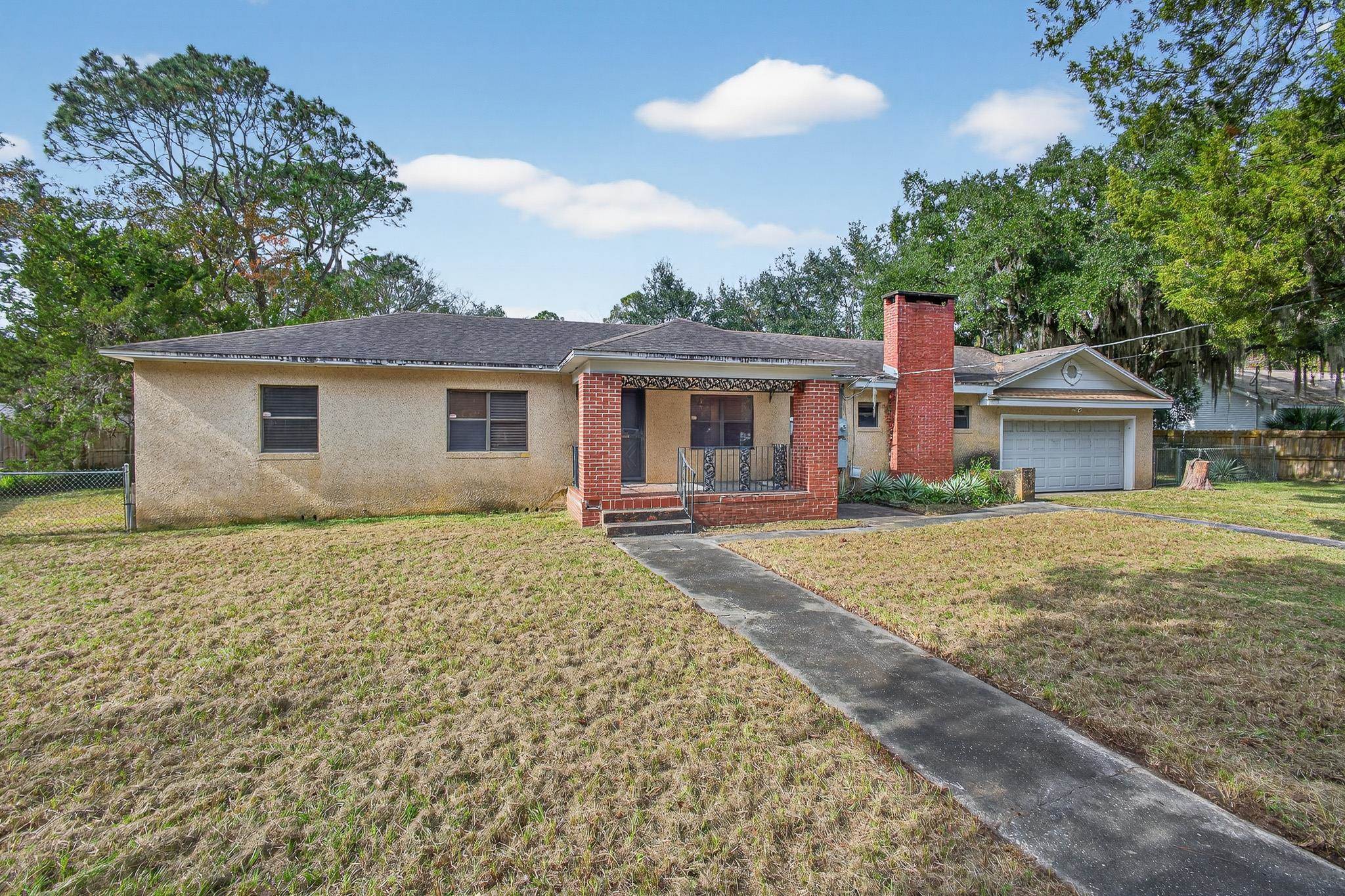 2907 North 5th Street St. Augustine, FL 32084 - Photo 69 of 71 Ranch-style home with a chimney, brick siding, a porch, an attached garage, and a shingled roof