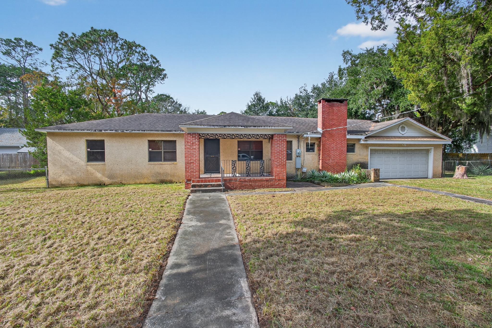 2907 North 5th Street St. Augustine, FL 32084 - Photo 70 of 71 Ranch-style house with a chimney, a porch, brick siding, a shingled roof, and an attached garage