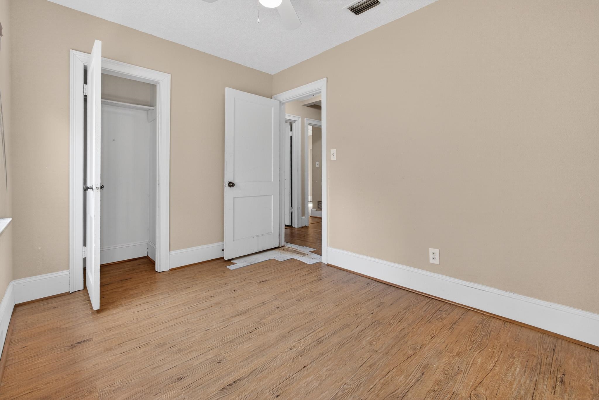 2907 North 5th Street St. Augustine, FL 32084 - Photo 10 of 71 Unfurnished bedroom featuring light wood-style flooring, ceiling fan, and a closet