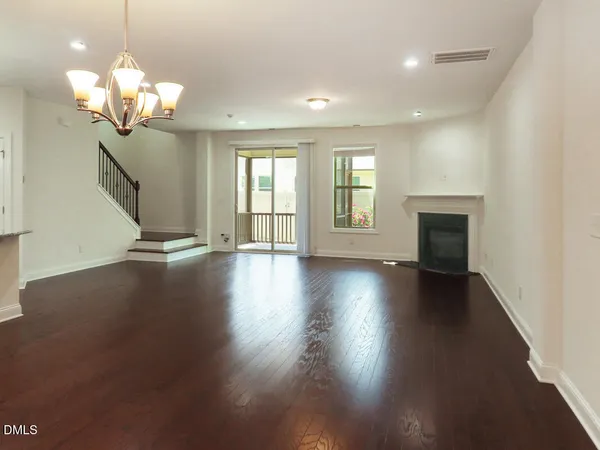 a view of a livingroom with hardwood floor and a ceiling fan