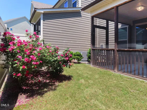 a flower garden in front of a house