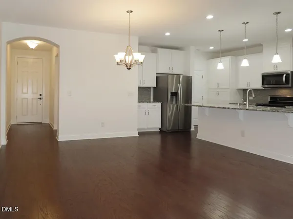 a view of a kitchen and a refrigerator