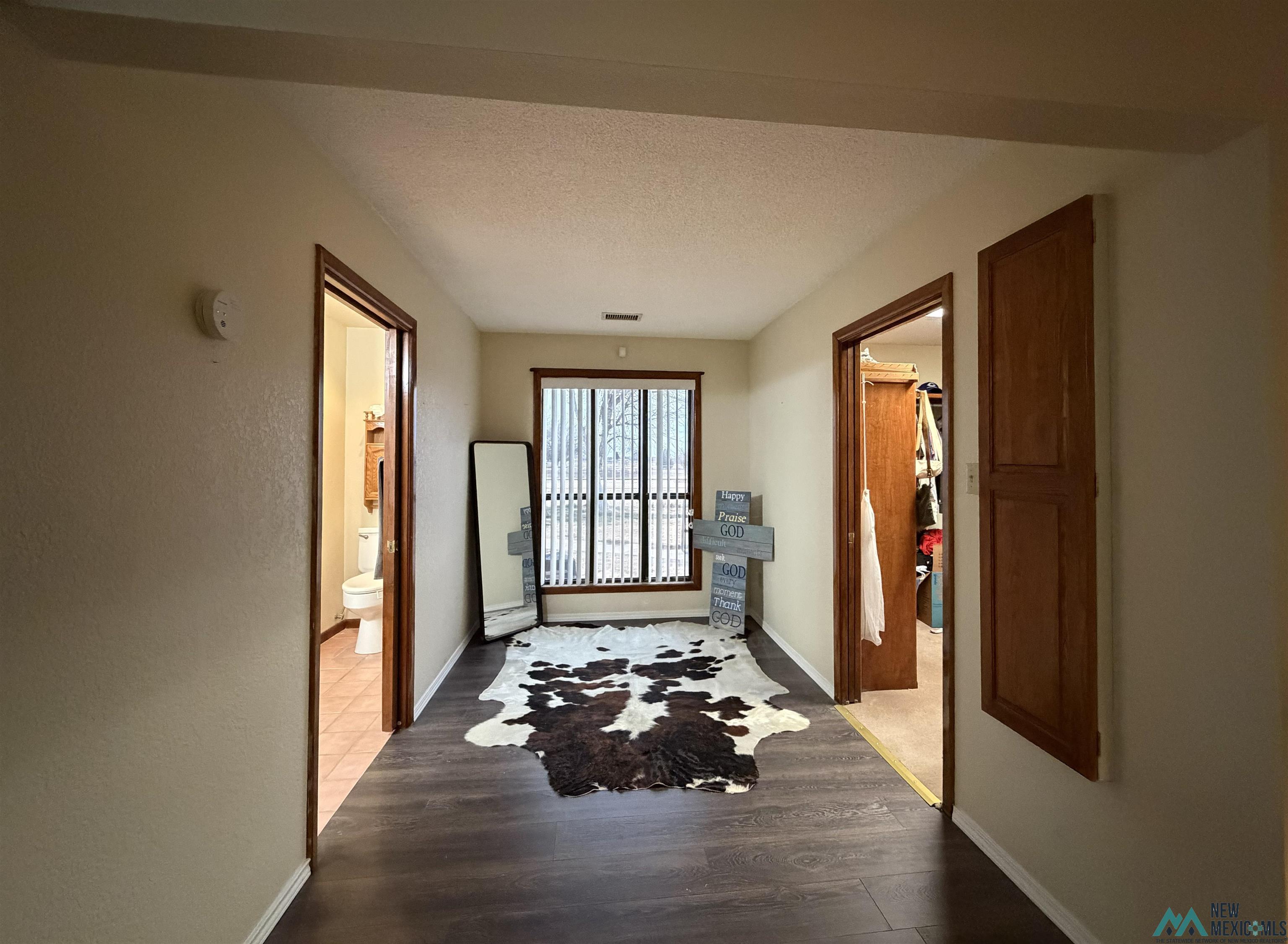 2001 East Derrick Road Carlsbad, NM 88220 - Photo 74 of 84 Entryway featuring wood finished floors and a textured ceiling