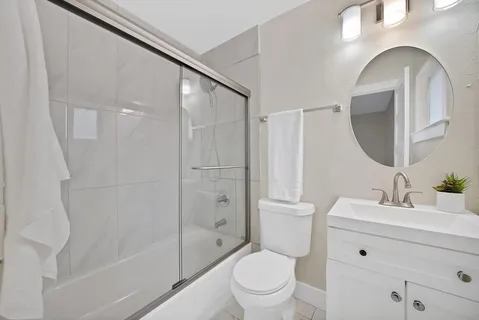 a bathroom with a toilet sink and shower