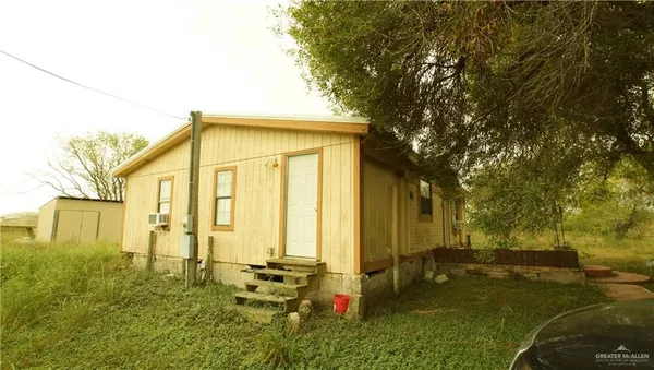 a backyard of a house with lots of green space