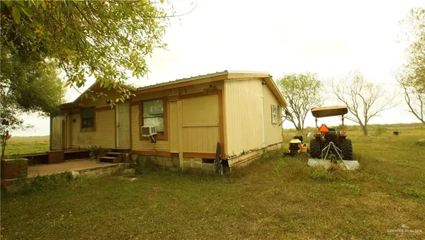 a view of a house with a backyard