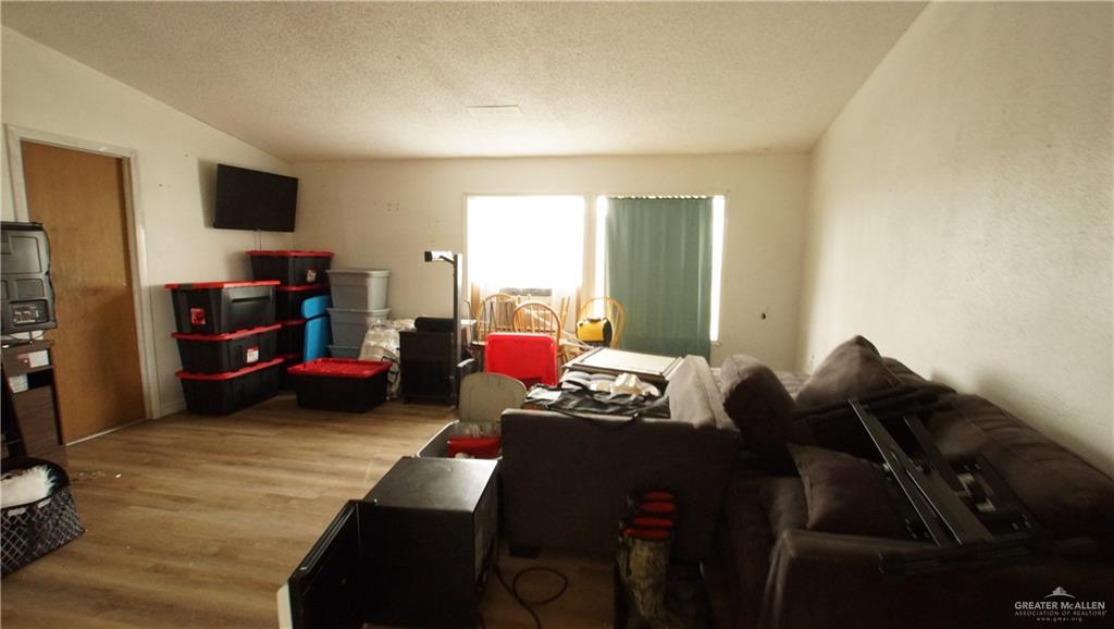 29833 Fernando East Road Rio Hondo, TX 78583 - Photo 10 of 15 a living room with furniture and a flat screen tv