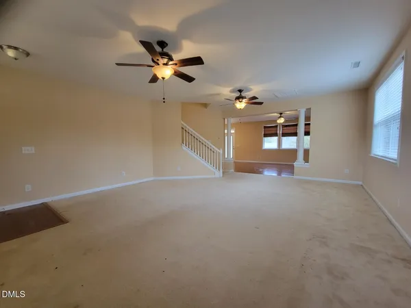 a view of a livingroom with a ceiling fan and window