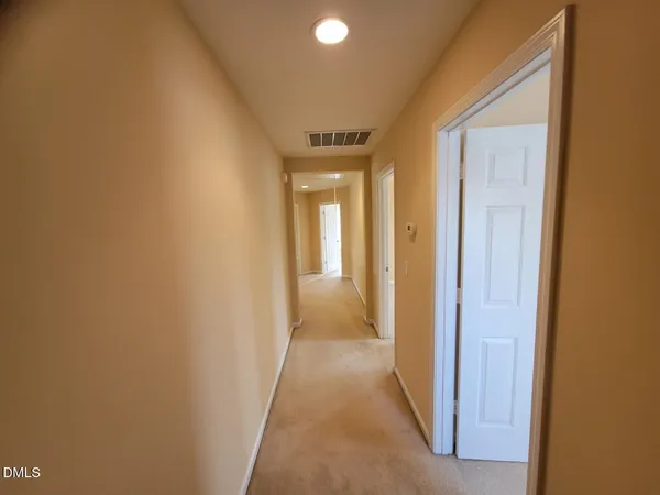 a view of a hallway with wooden shelves