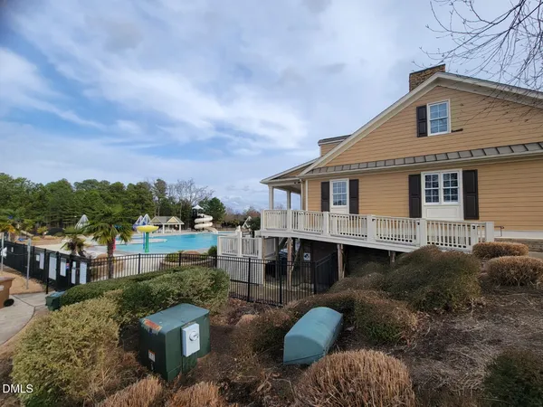 a aerial view of a house with a yard and balcony