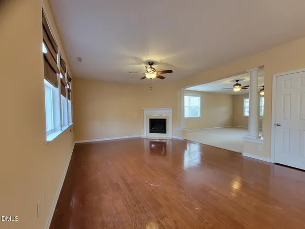 wooden floor in an empty room with a window