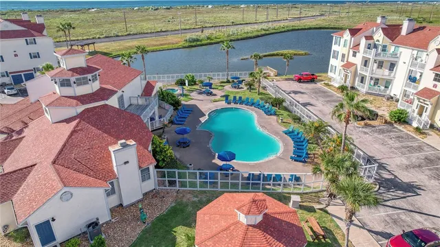 an aerial view of a house with a garden and parking space