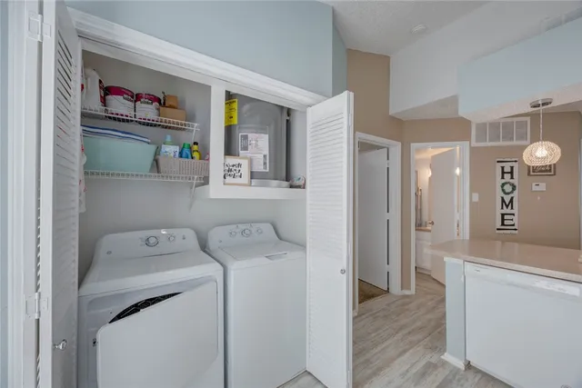 a utility room with sink dryer and washer