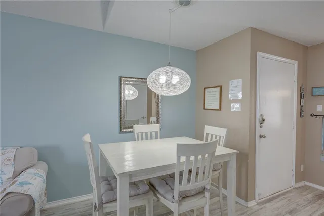 a view of a dining room with furniture and a chandelier fan