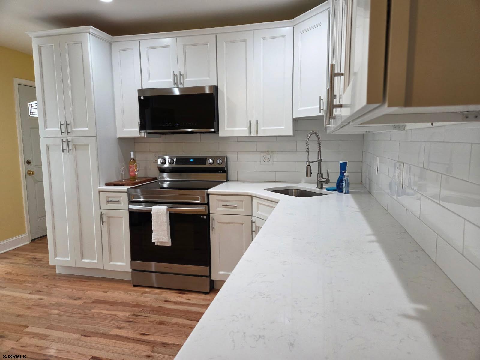 131 Jones Kane Road Williamstown, NJ 08094 - Photo 3 of 18 a kitchen with stainless steel appliances granite countertop a stove a microwave and a refrigerator