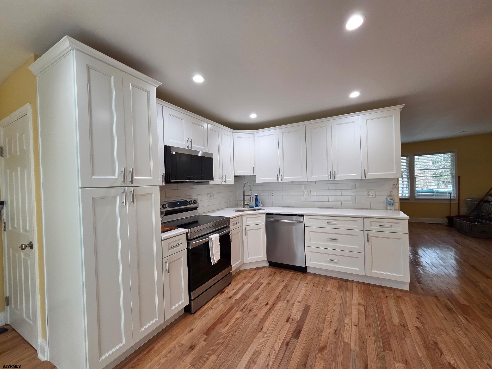 131 Jones Kane Road Williamstown, NJ 08094 - Photo 5 of 18 a kitchen with granite countertop appliances cabinets and a wooden floor