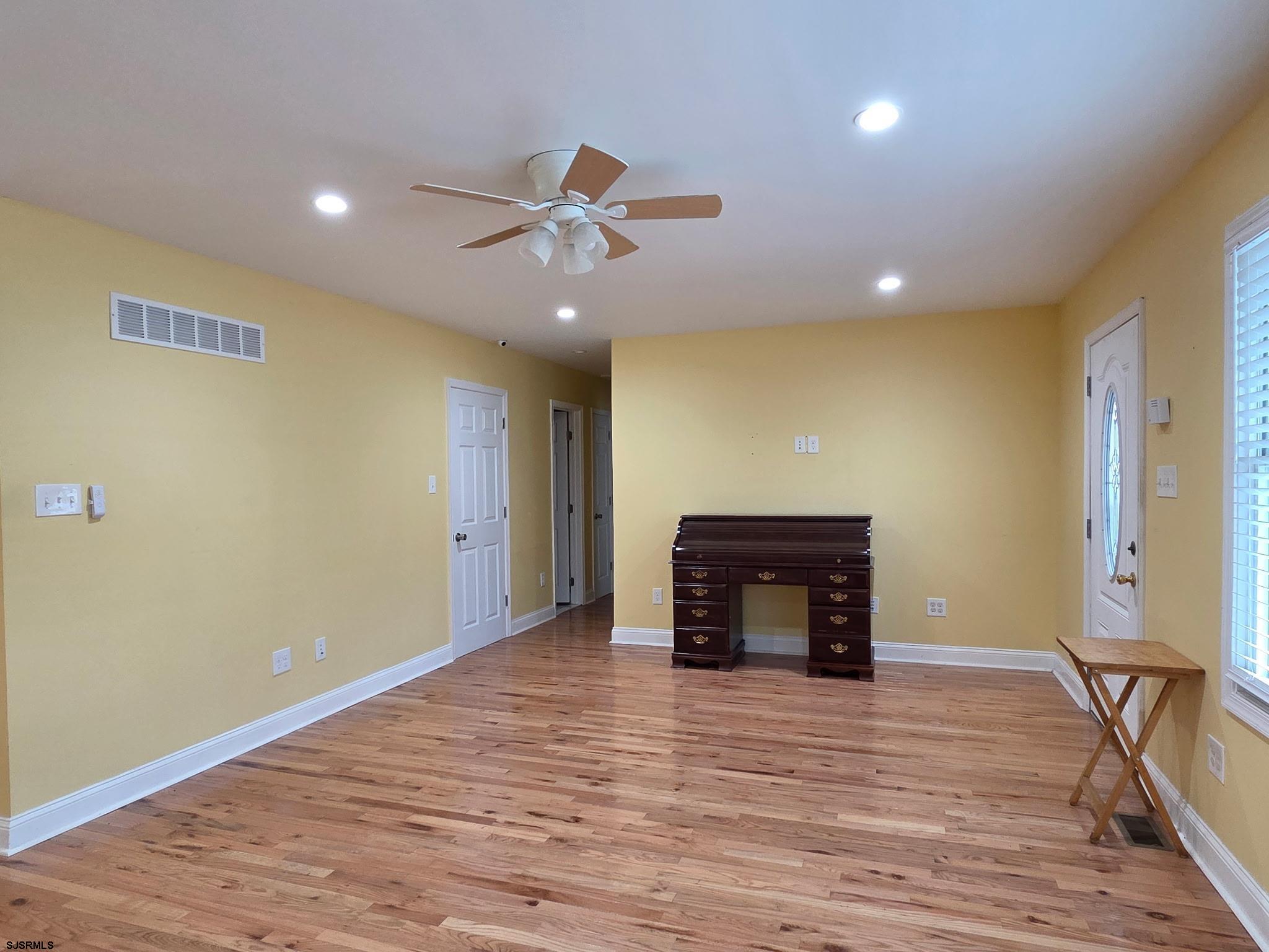 131 Jones Kane Road Williamstown, NJ 08094 - Photo 8 of 18 a view of empty room with wooden floor and fan