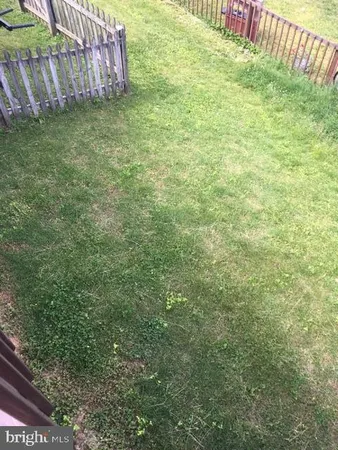 a view of a house with wooden fence