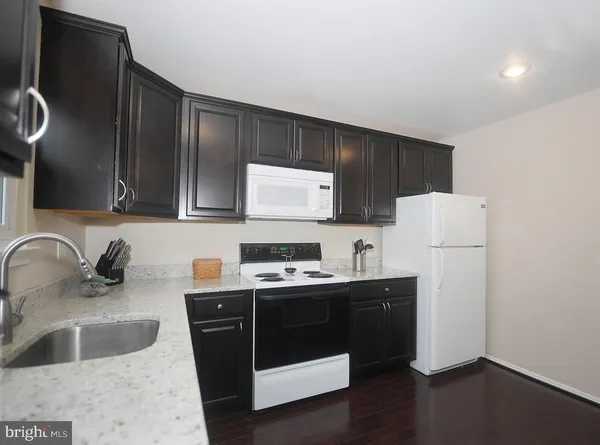 a kitchen with a sink a stove and refrigerator