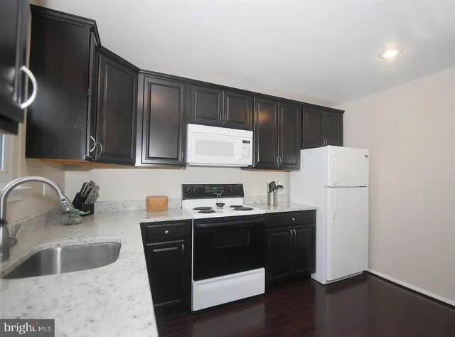 a kitchen with a sink a stove and refrigerator