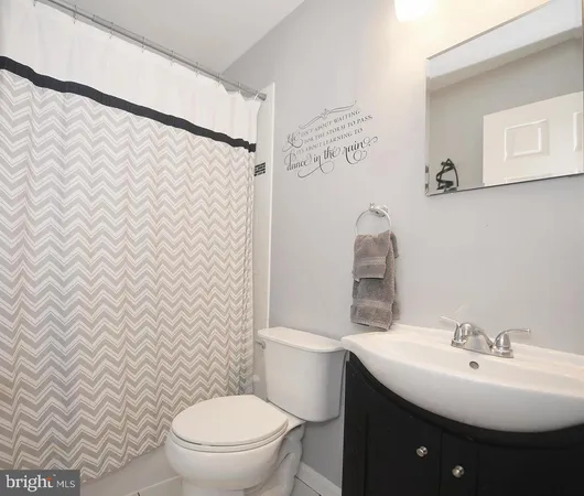 a bathroom with a sink toilet and a mirror