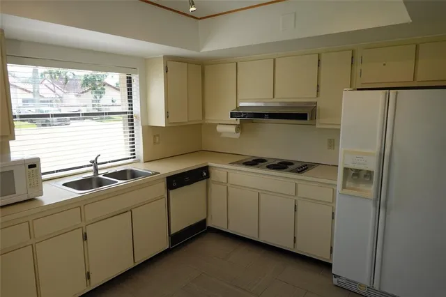 a kitchen with a sink cabinets and window