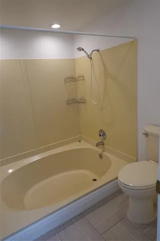 a bathroom with a bathtub and a toilet