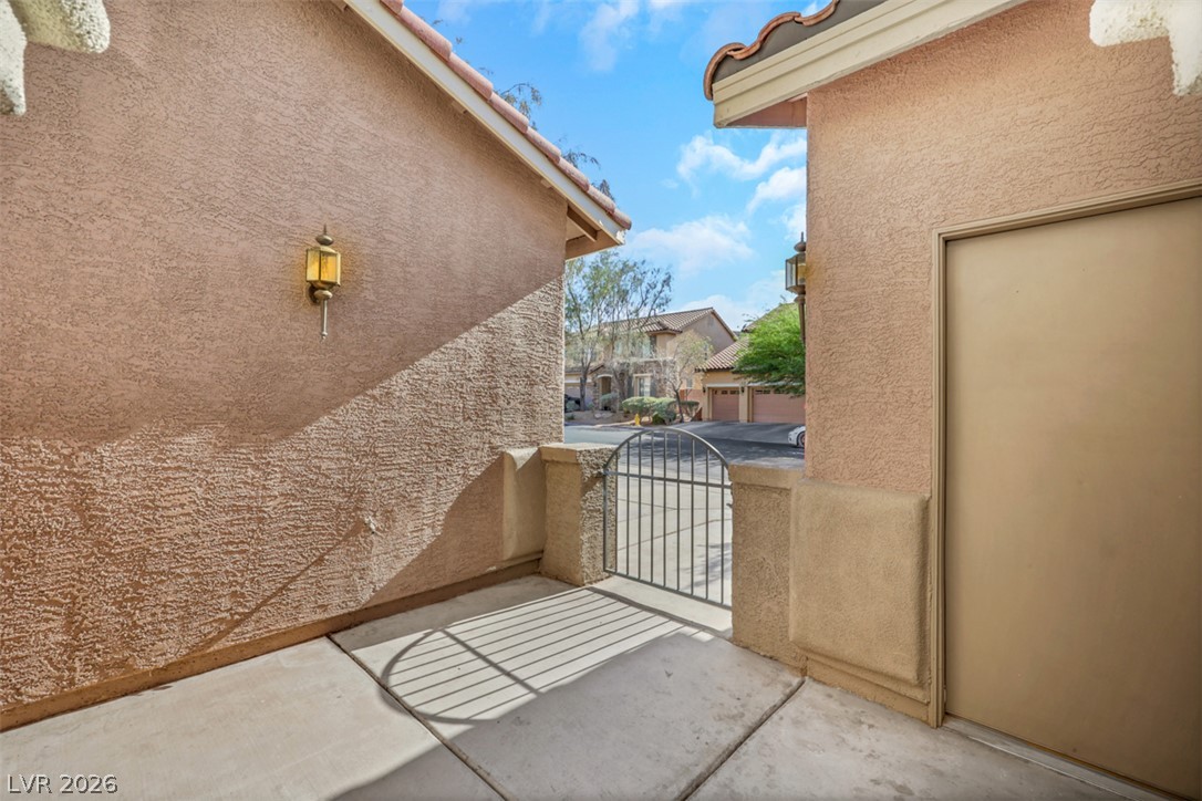 10328 Hawk Ravine Street Las Vegas, NV 89178 - Photo 49 of 55 A private gated entry courtyard provides a warm welcome to this inviting residence.