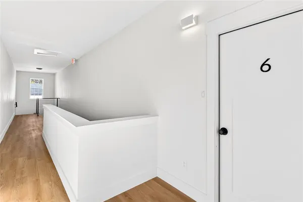 a view of a big room with closet and wooden floor
