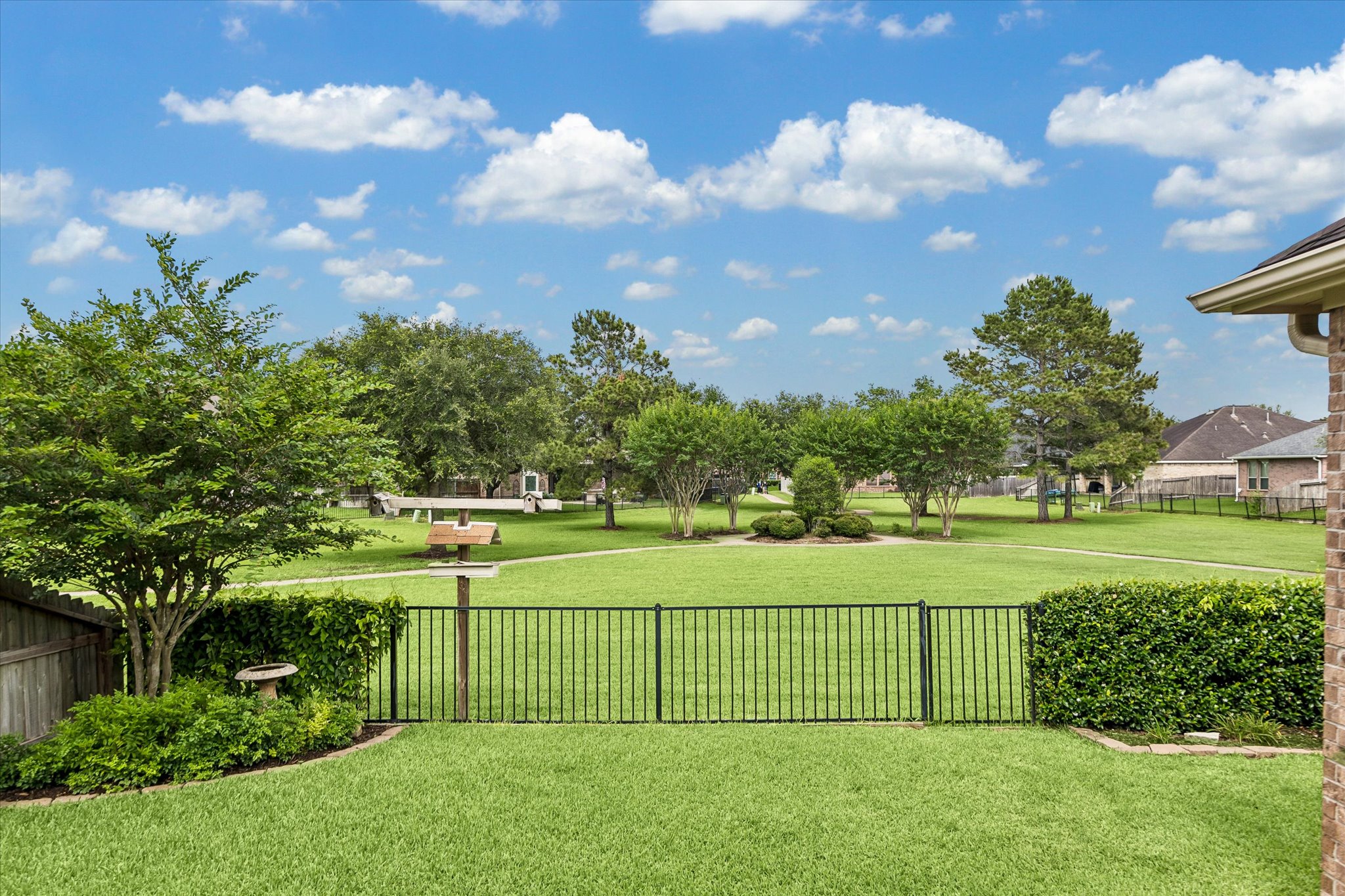 2214 Wembley Way Rosenberg, TX 77471 - Photo 17 of 35 Expansive green lawn extending to a communal green space with mature trees and landscaping