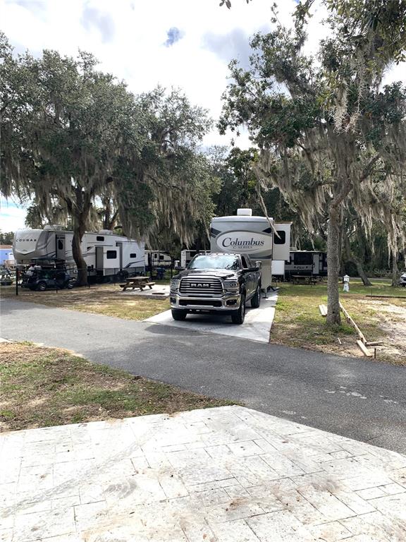15991 Northeast 243rd Place Road, Unit 54 Fort McCoy, FL 32134 - Photo 2 of 4 a view of a street with a cars park side of the road