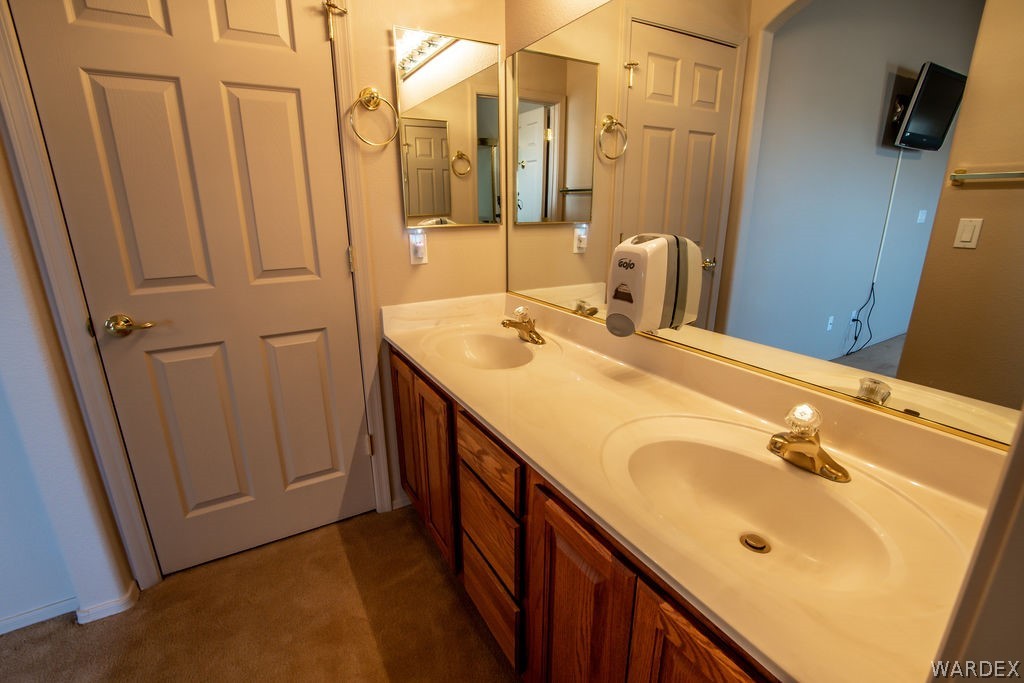 4213 East Cane Ranch Road Kingman, AZ 86401 - Photo 12 of 40 a bathroom with a double vanity sink and a mirror
