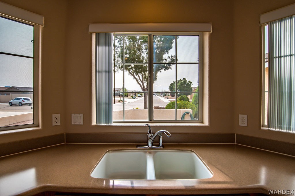 4213 East Cane Ranch Road Kingman, AZ 86401 - Photo 2 of 40 a bathroom with a sink window and a mirror