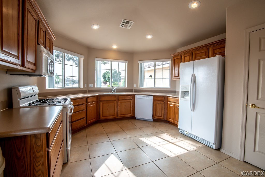 4213 East Cane Ranch Road Kingman, AZ 86401 - Photo 3 of 40 a kitchen with a sink a window and stainless steel appliances
