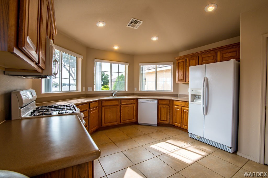 4213 East Cane Ranch Road Kingman, AZ 86401 - Photo 5 of 40 a kitchen with a refrigerator a sink and cabinets