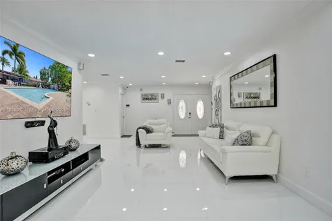 a living room with furniture and a floor to ceiling window