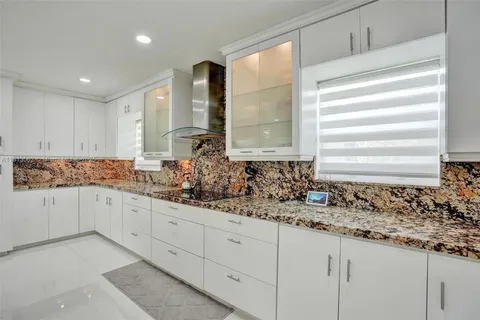 a kitchen with a sink and a chandelier