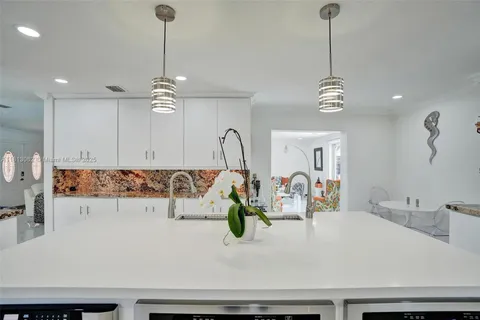 a bathroom with sink wooden floor and window