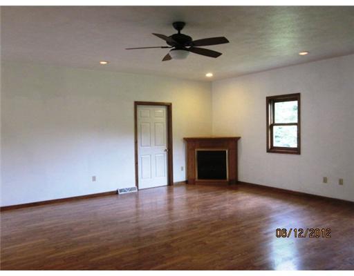 377 Smithcreek Road Spraggs, PA 15362 - Photo 4 of 13 Living Room. Spacious living room with gas log fireplace and laminate flooring