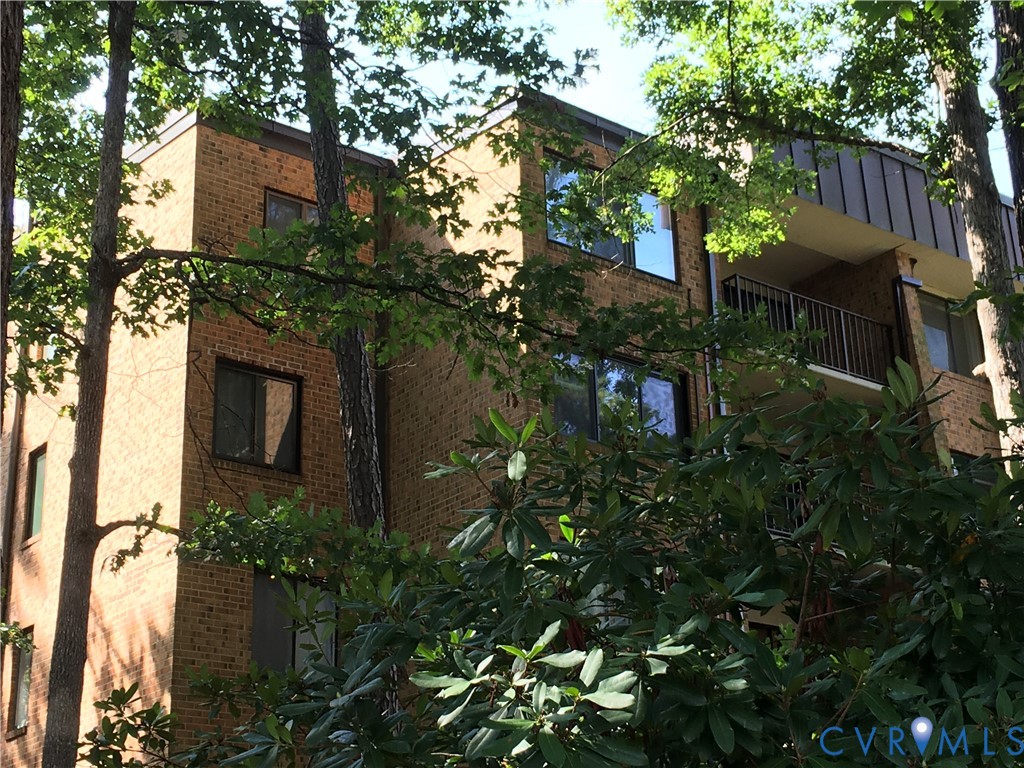 1501 Regency Woods Road, Unit 303 Henrico, VA 23238 - Photo 17 of 24 a house that has a tree in front of it