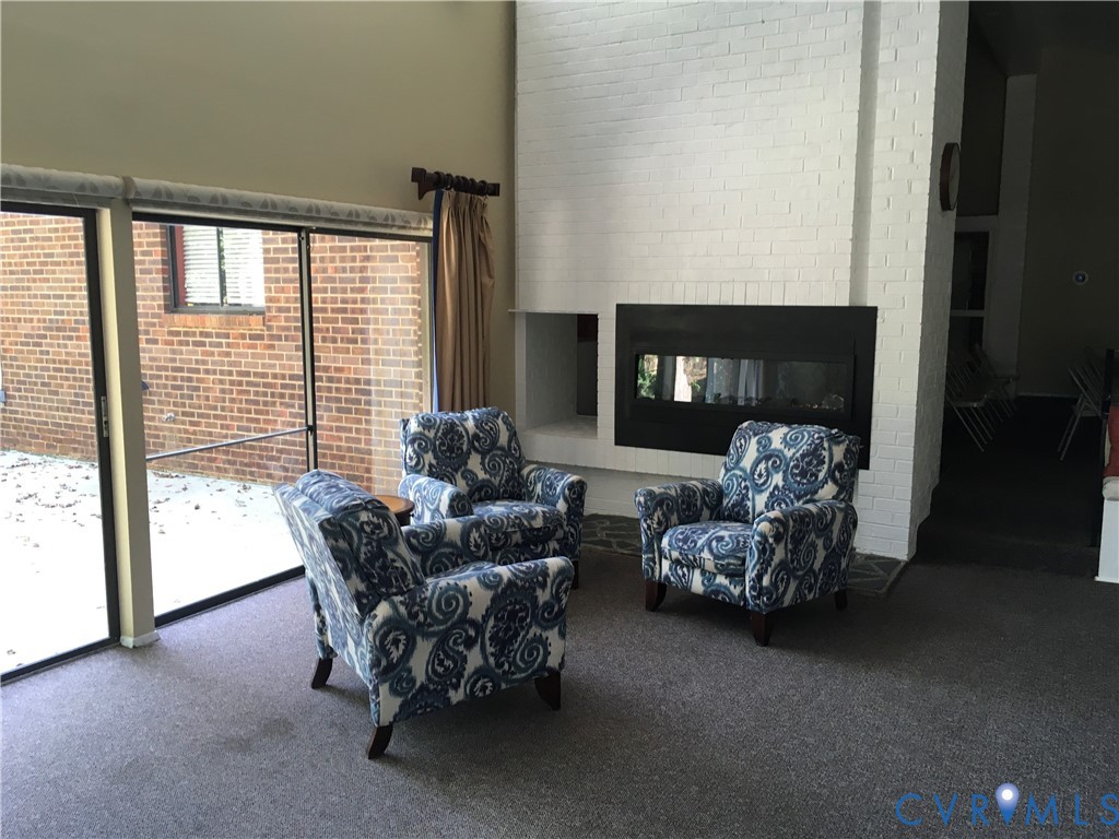 1501 Regency Woods Road, Unit 303 Henrico, VA 23238 - Photo 22 of 24 a living room with furniture and floor to ceiling window