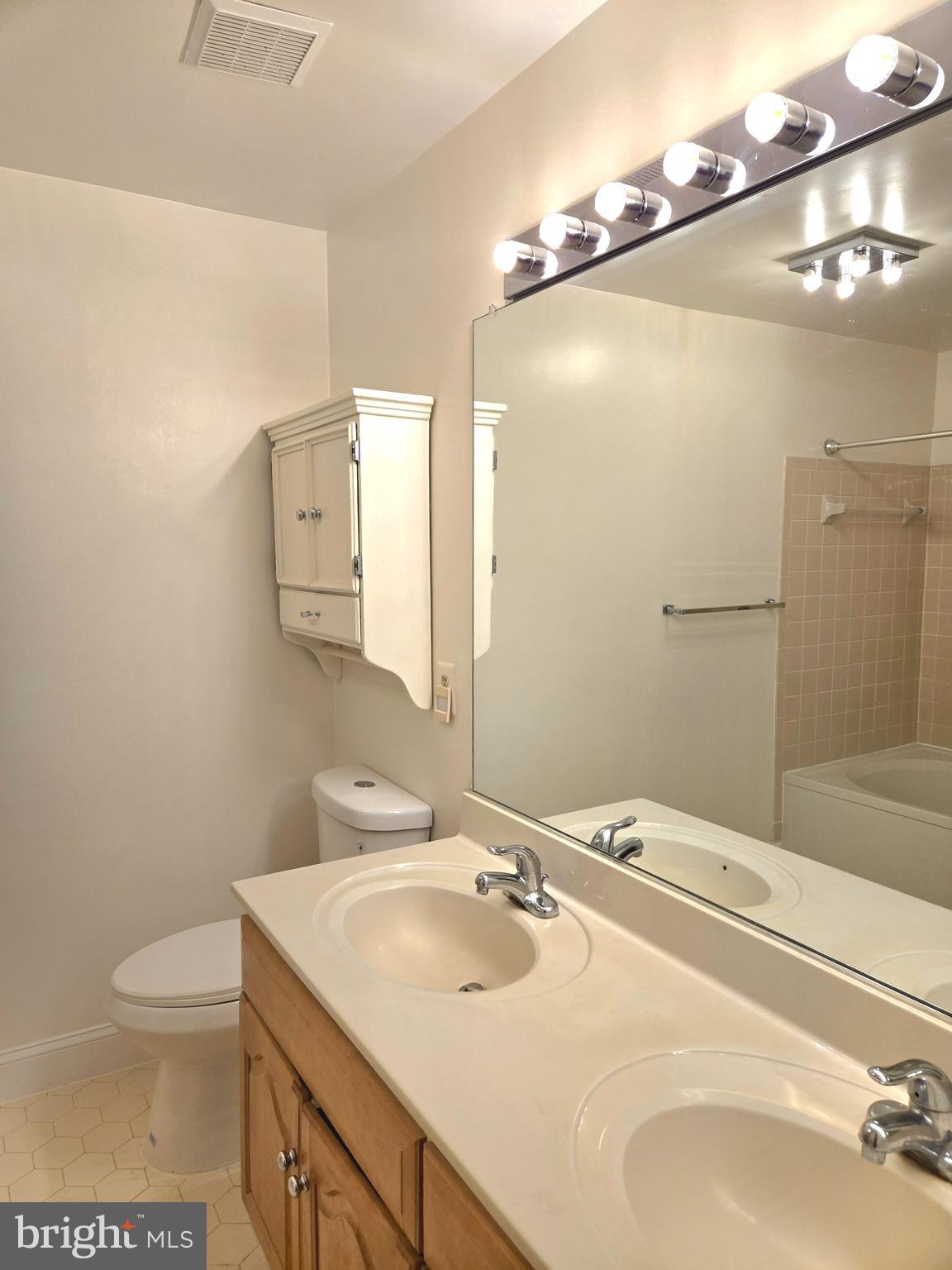 1537 Church Hill Place, Unit 1537 Reston, VA 20194 - Photo 12 of 40 a bathroom with a sink and mirror