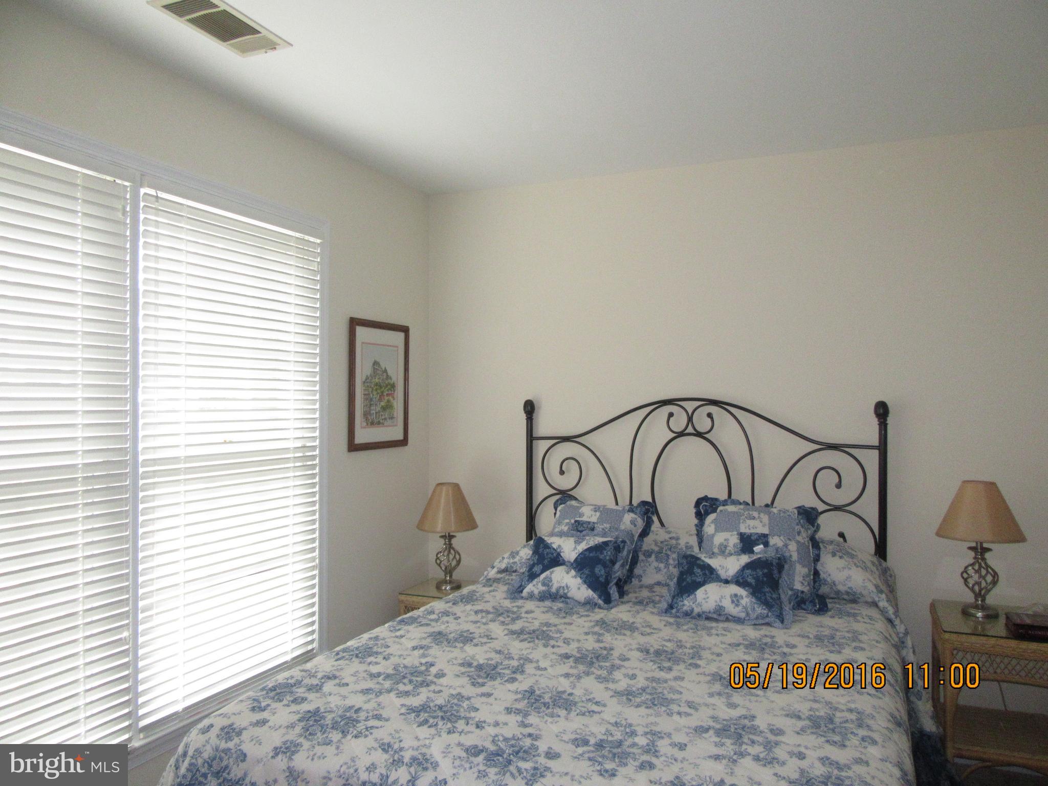 1537 Church Hill Place, Unit 1537 Reston, VA 20194 - Photo 15 of 40 a view of a bedroom with a table and a chair