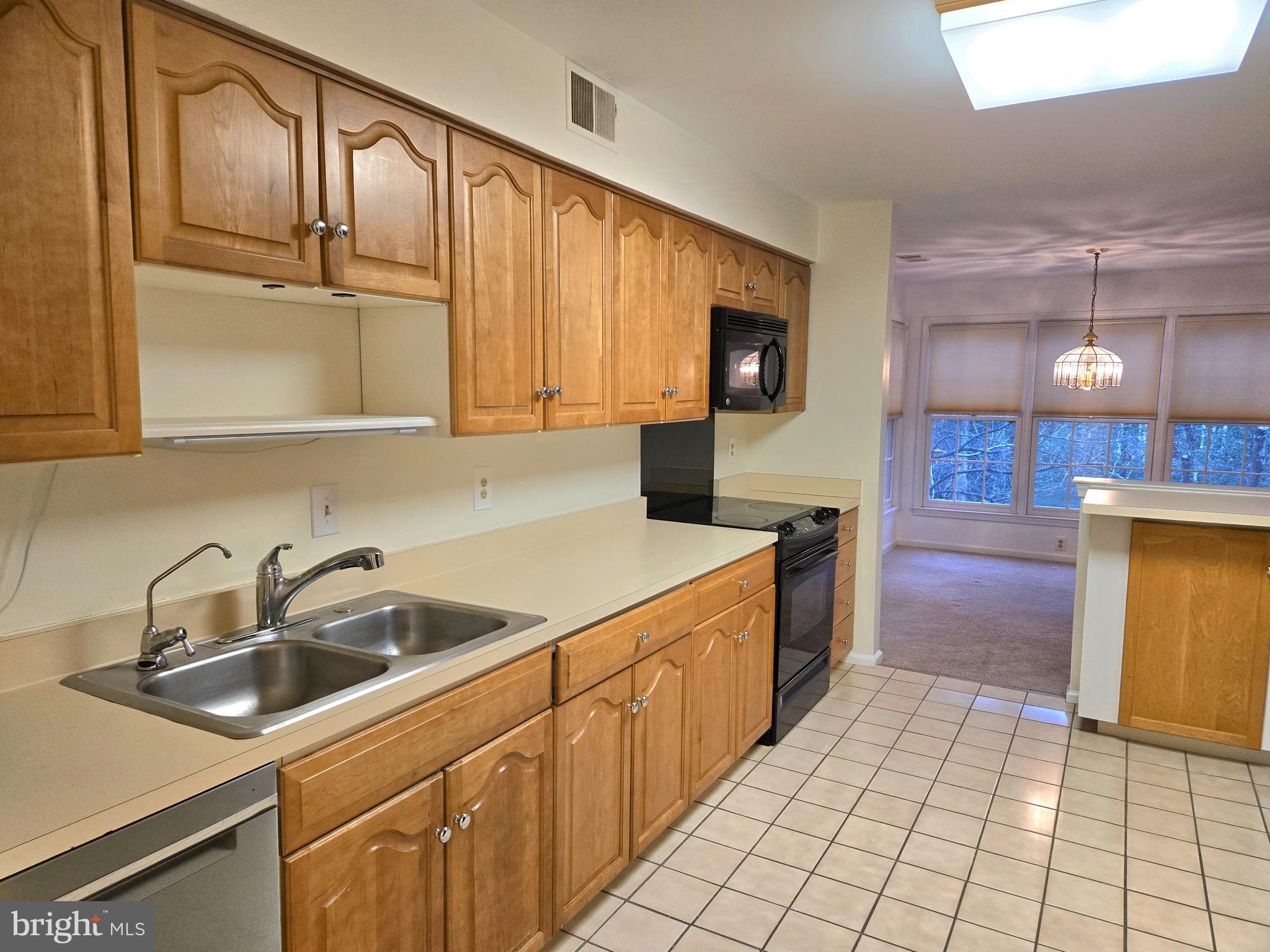 1537 Church Hill Place, Unit 1537 Reston, VA 20194 - Photo 4 of 40 a kitchen with a sink cabinets and window